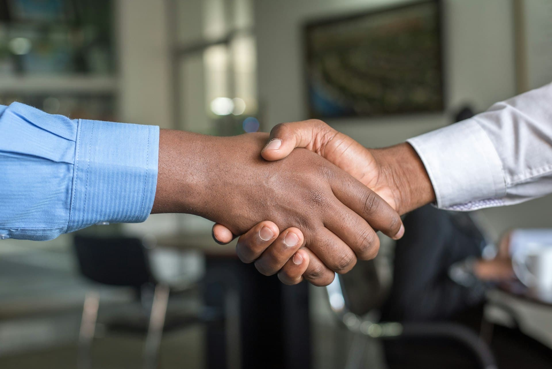Two professionals shaking hands in an office